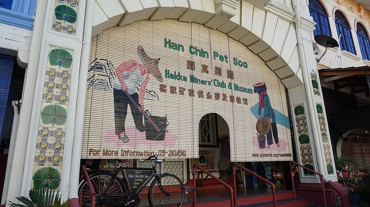 Shuttered front of the Han Chin Pet Soo Hakka miners club and museum with a painted mural