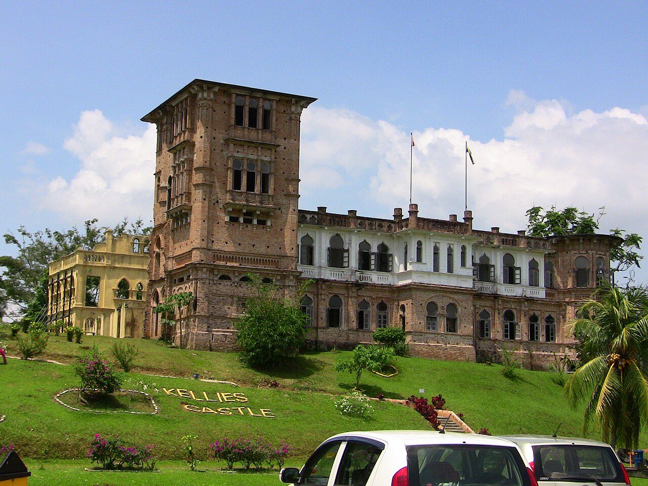 Kellie's Castle in Batu Gajah, a large unfinished mansion with a tall tower seen from the lawn