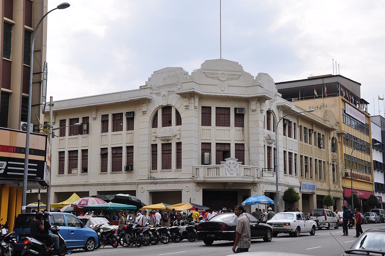 Ipoh nightclubs guide: white Art Deco heritage building on a busy street in central Ipoh, photographed in daytime