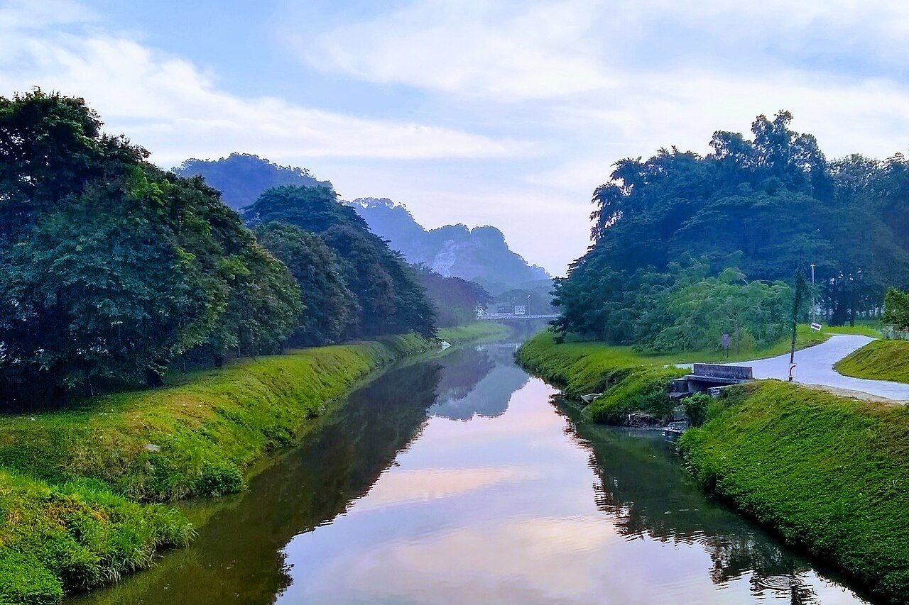 Ipoh nature and outdoors: the Kinta River in Ipoh with grassy banks and wooded limestone hills behind