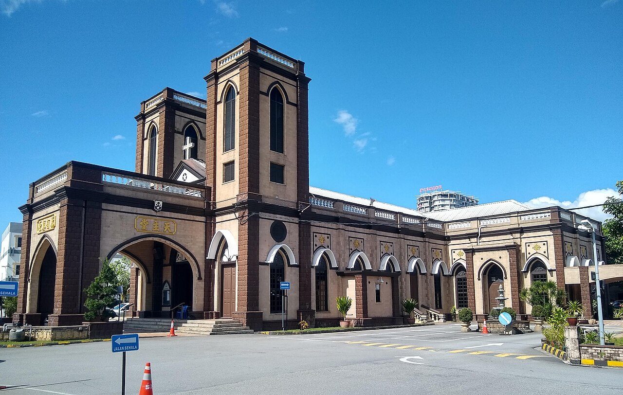 Brown brick St Michael's Church in Ipoh with its tall entrance tower and forecourt