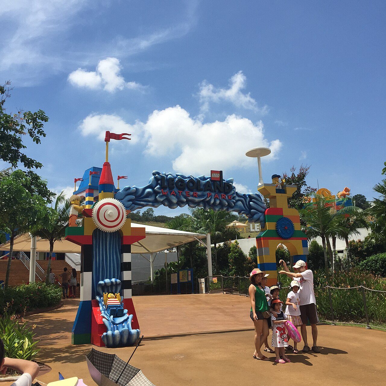 The blue wave-shaped arch over the entrance to the LEGOLAND Water Park in Malaysia, with LEGO figures on brick towers