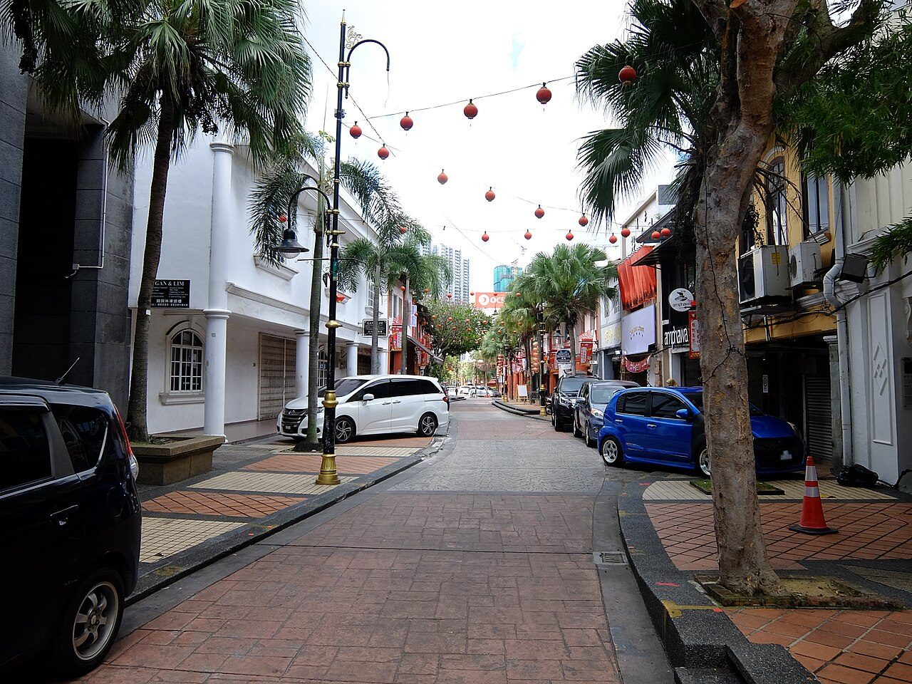 Jalan Tan Hiok Nee in Johor Bahru with red lanterns strung over the street and heritage shophouses, the old-town street where several Johor Bahru cafes trade