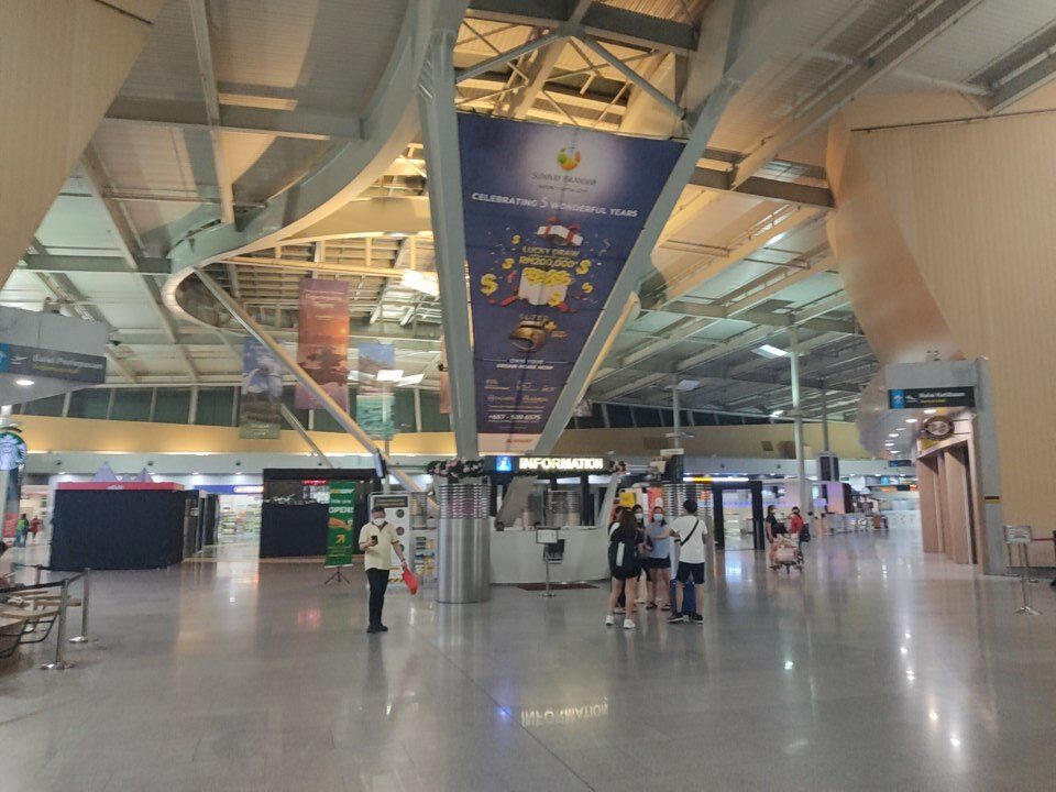 Car rental in Johor Bahru: the arrivals hall of Senai International Airport with its information counter under a high steel roof