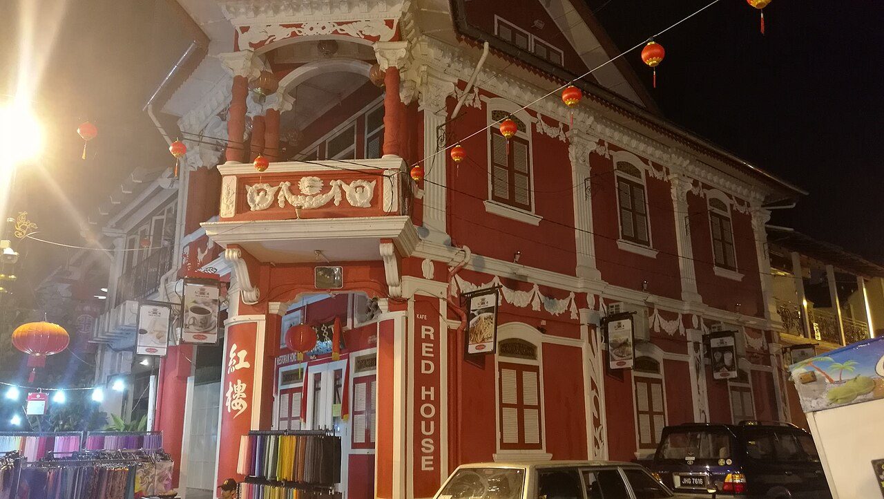 Red House, a red and white heritage shophouse on Jalan Tan Hiok Nee lit up at night, on the street where several Johor Bahru drinks stops in this guide serve kopi
