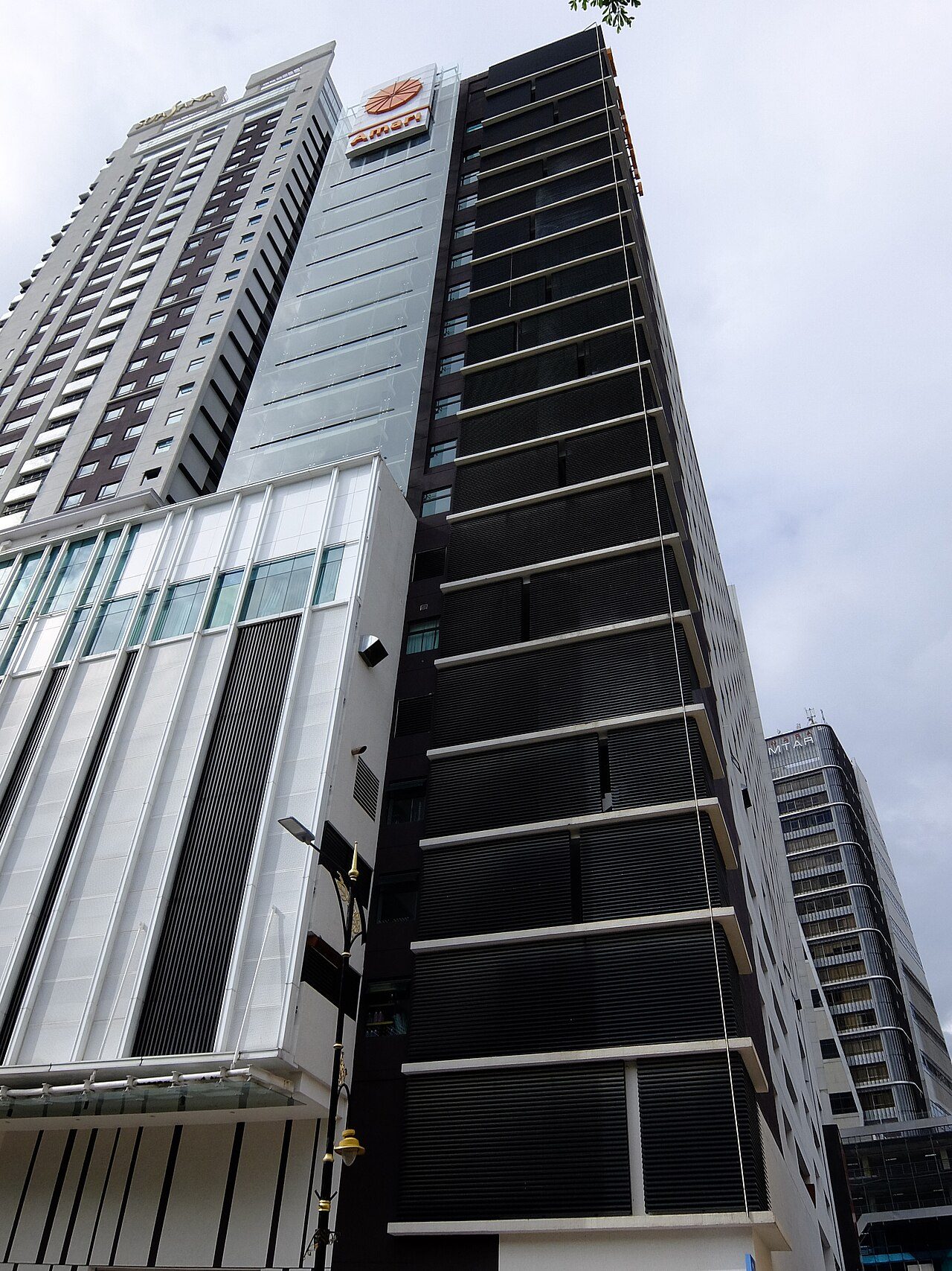Amari Johor Bahru, a dark tower with horizontal louvres and the orange Amari sign near the top, on Jalan Wong Ah Fook