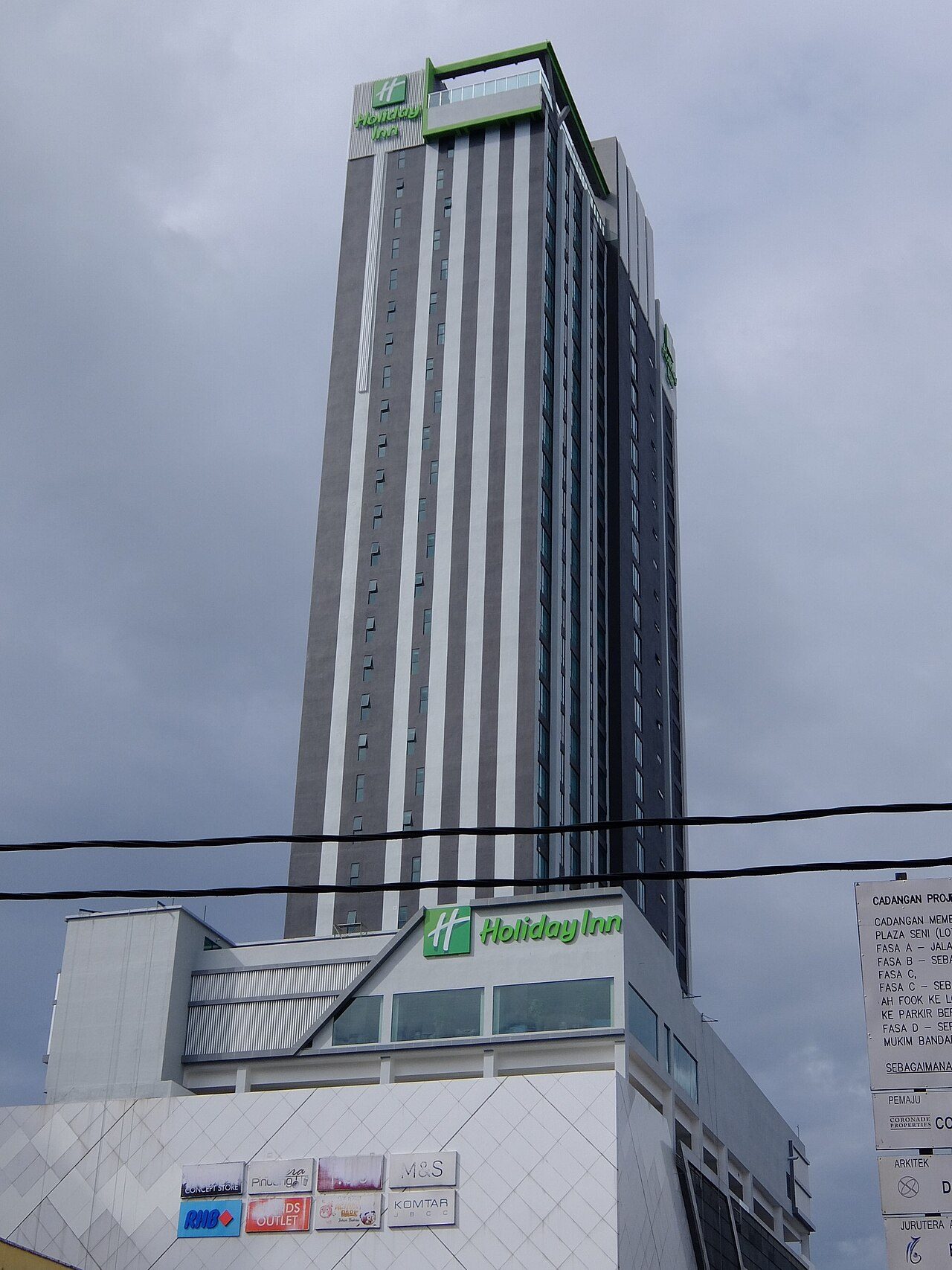 Holiday Inn Johor Bahru City Centre, a tall grey tower with green Holiday Inn signs above the Komtar JBCC mall