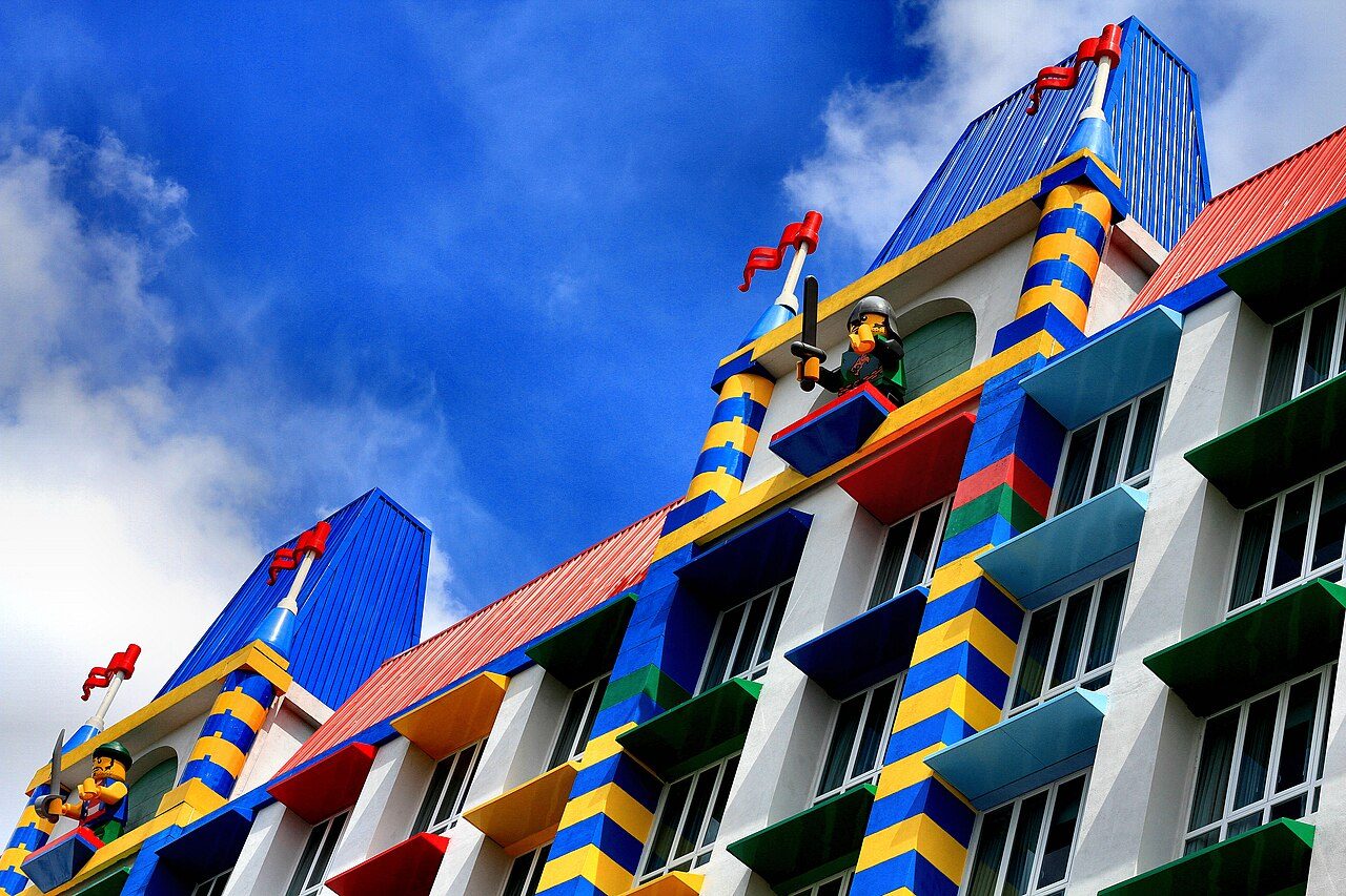 LEGOLAND Malaysia Hotel facade with brick-style striped columns, coloured window ledges and LEGO knight figures on the towers
