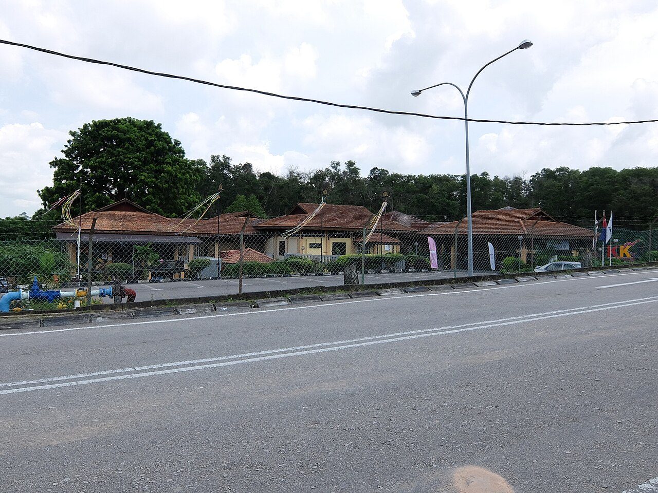 Low buildings with traditional Malay-style roofs at the Johor Craft Complex in Larkin, seen from the road
