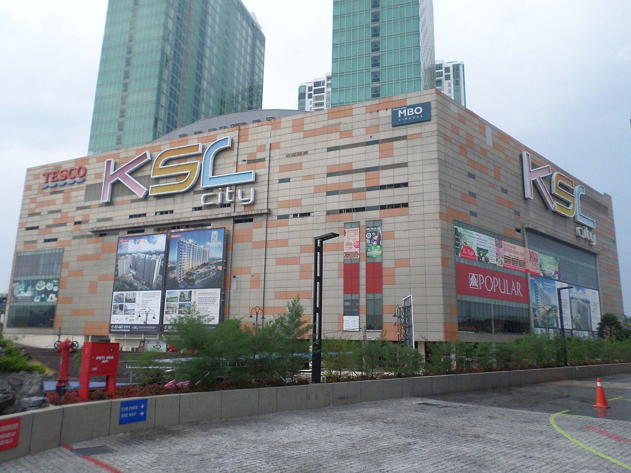 KSL City Mall in Johor Bahru, a large beige and orange block with the KSL City sign, and two green glass towers behind it