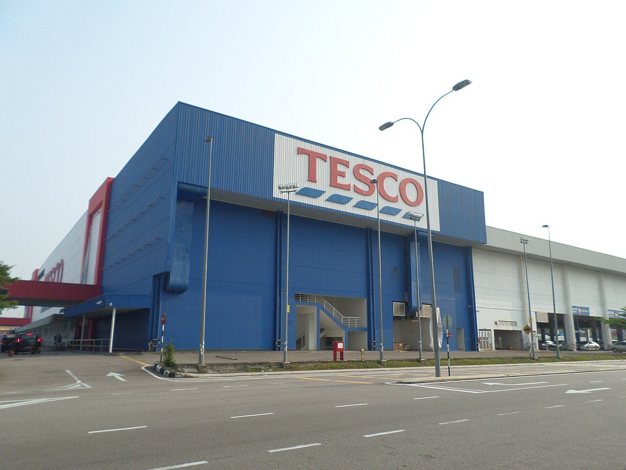 The blue hypermarket building in Bukit Indah in 2015, then branded Tesco, with an empty road in front