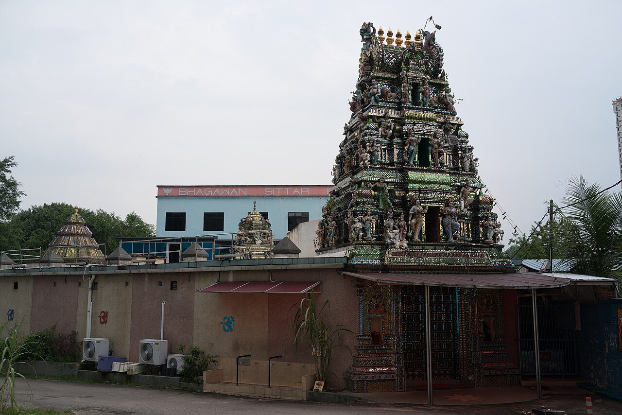 The gopuram of the Arulmigu Sri Rajakaliamman Glass Temple in Johor Bahru, covered in painted figures and glass mosaic