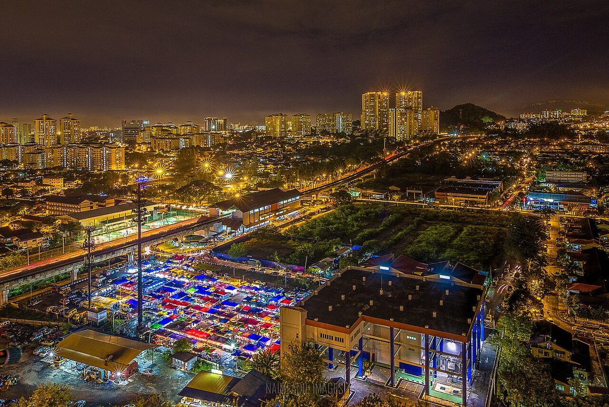 Coloured canopies of a pasar malam beside the elevated LRT line near Jelatek station, one of the night markets in Kuala Lumpur