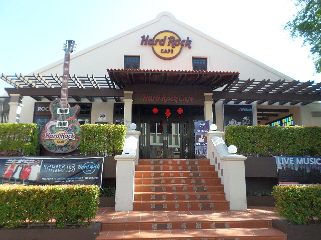 Melaka nightclubs guide: the front of Hard Rock Cafe Melaka with its guitar sign and a live music banner, in daylight