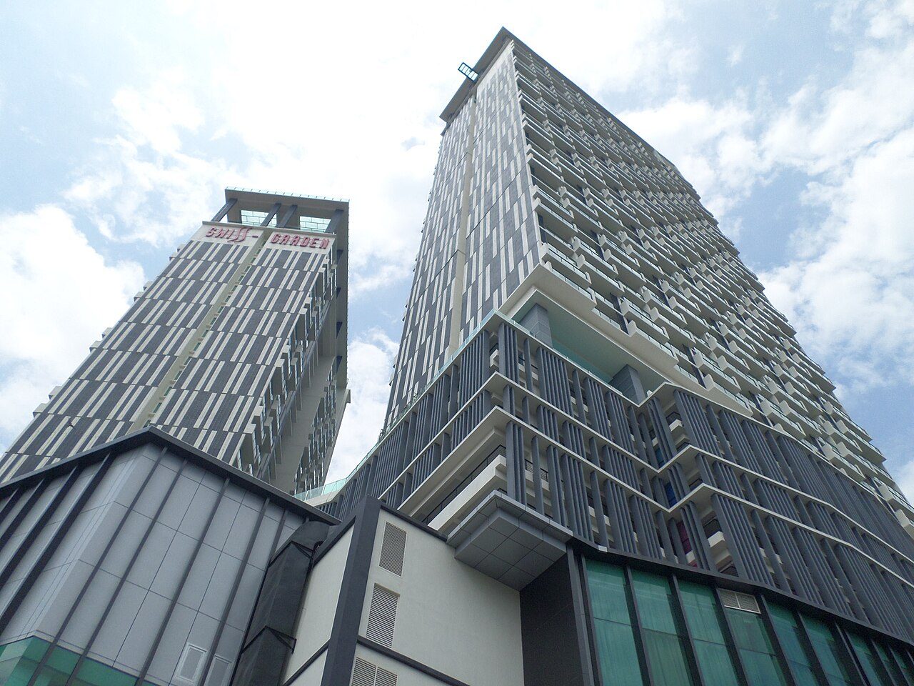 The Swiss-Garden Hotel Melaka towers at The Shore, seen from street level with the hotel sign at the top