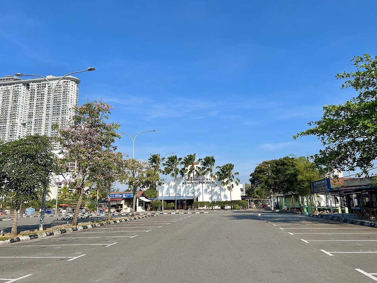 Medan Portugis in the Portuguese Settlement, Melaka, with the white Medan Selera Kampung Portugis building ahead and the Restoran De Lisbon sign on the right