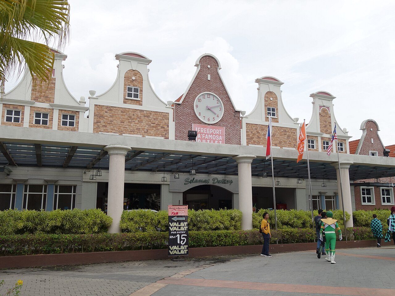 The entrance of Freeport A'Famosa Outlet, with Dutch-style gables, a clock and a Selamat Datang welcome sign