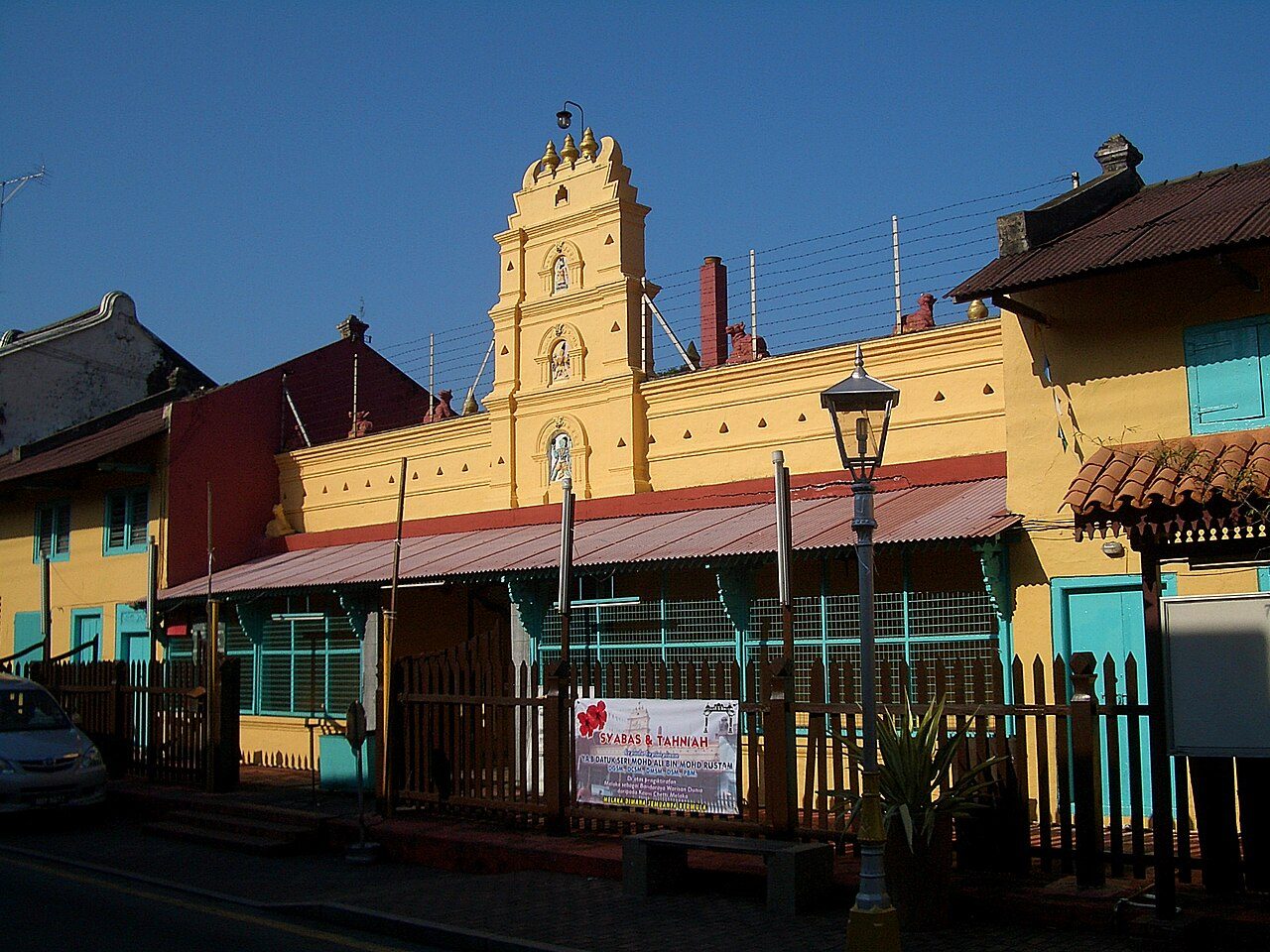 The yellow front of Sri Poyyatha Vinayagar Moorthi Temple on Jalan Tukang Emas with its small tiered tower