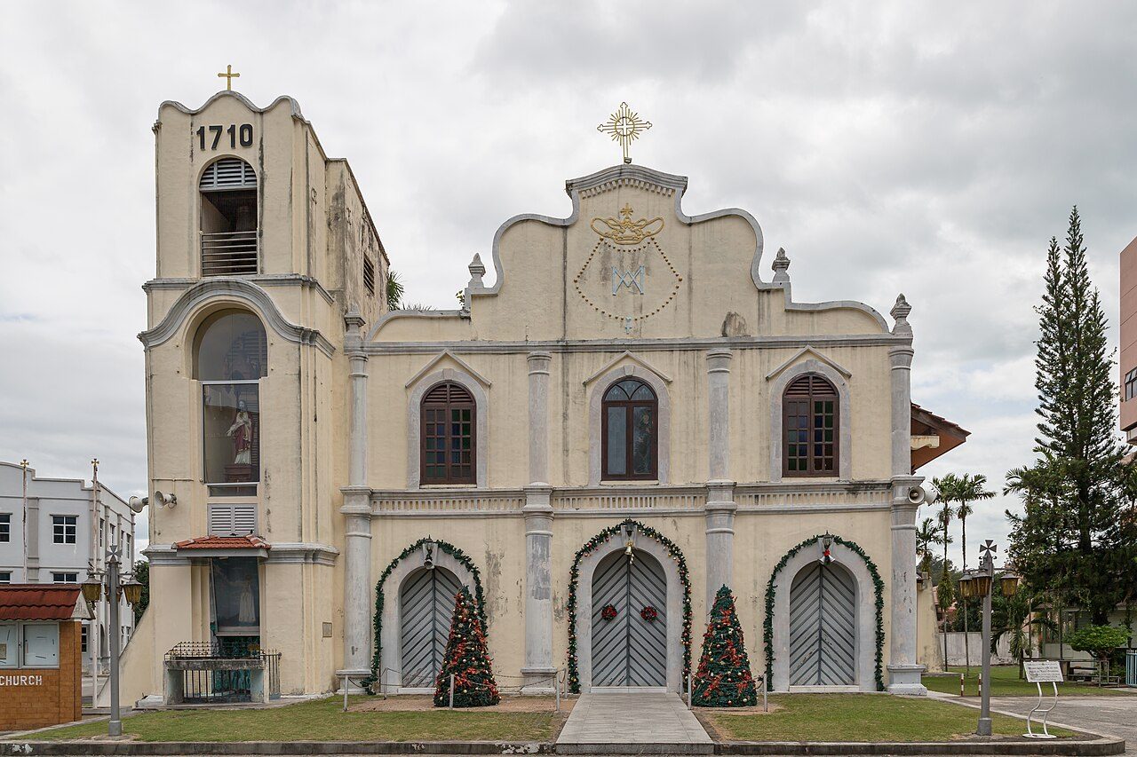 The cream facade of St Peter's Church in Melaka with its bell tower marked 1710