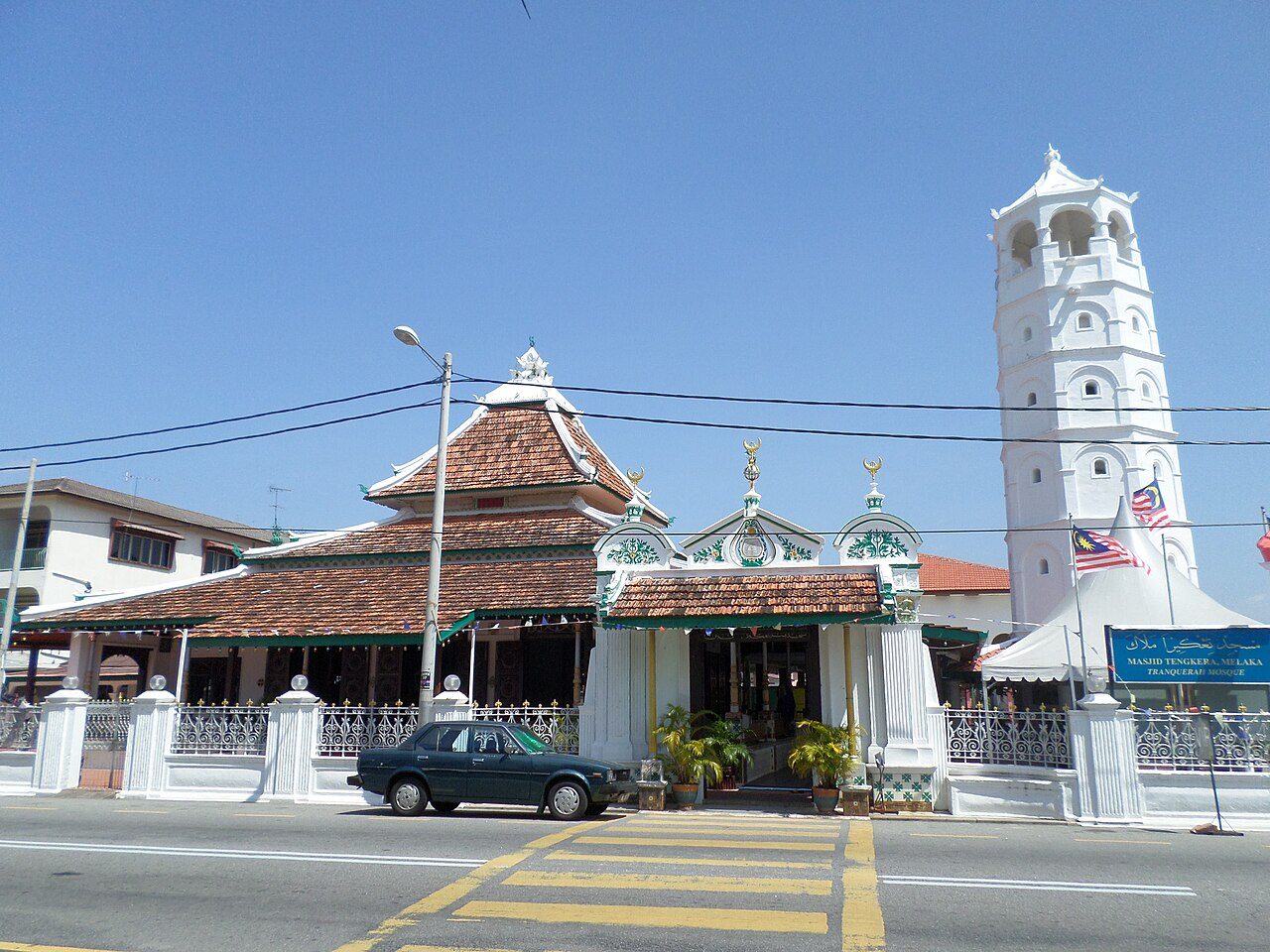 Tranquerah Mosque on Jalan Tengkera with its tiered tiled roof and a tall white pagoda-style minaret