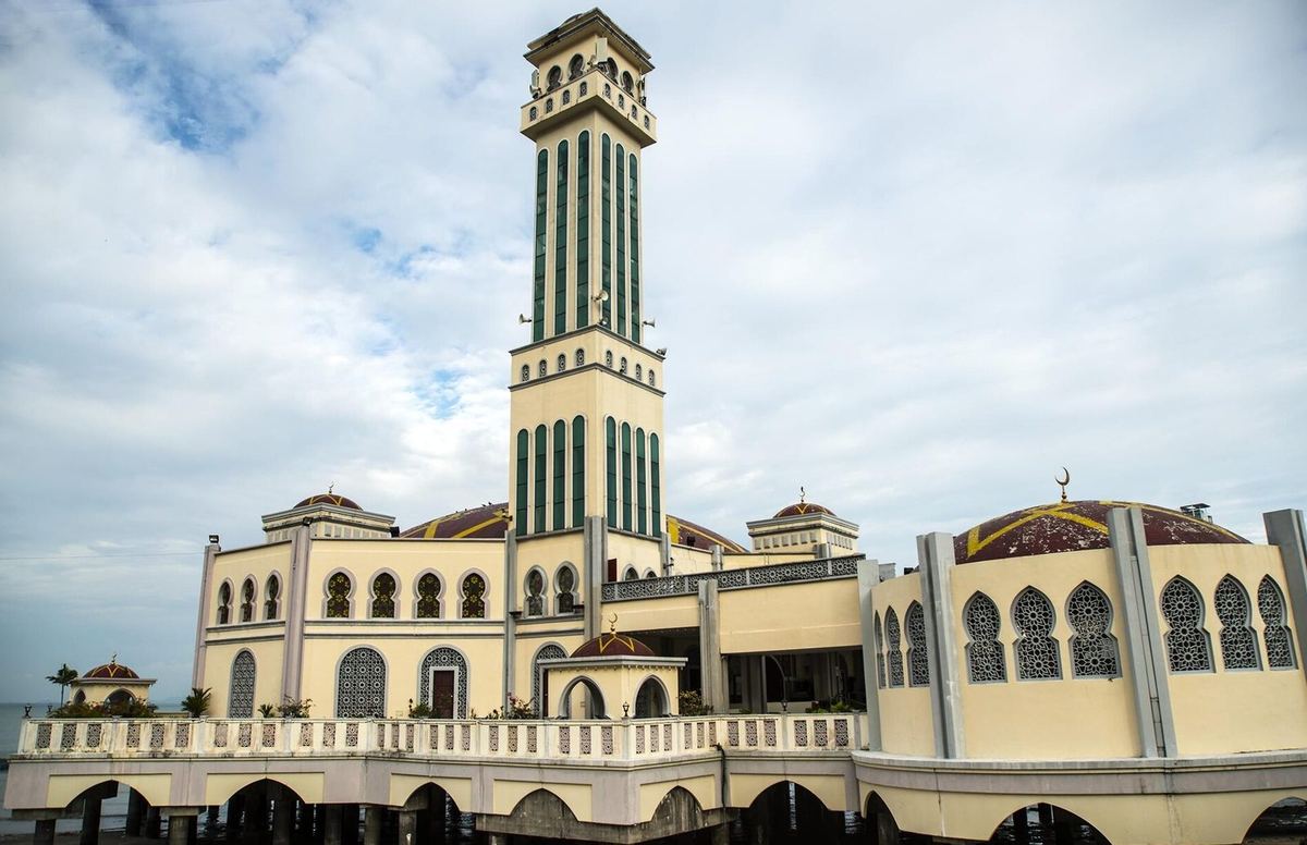 Tanjung Bungah Floating Mosque (Masjid Syed Sheikh Al-Hadi) on stilts over the sea, with its tall minaret, Penang