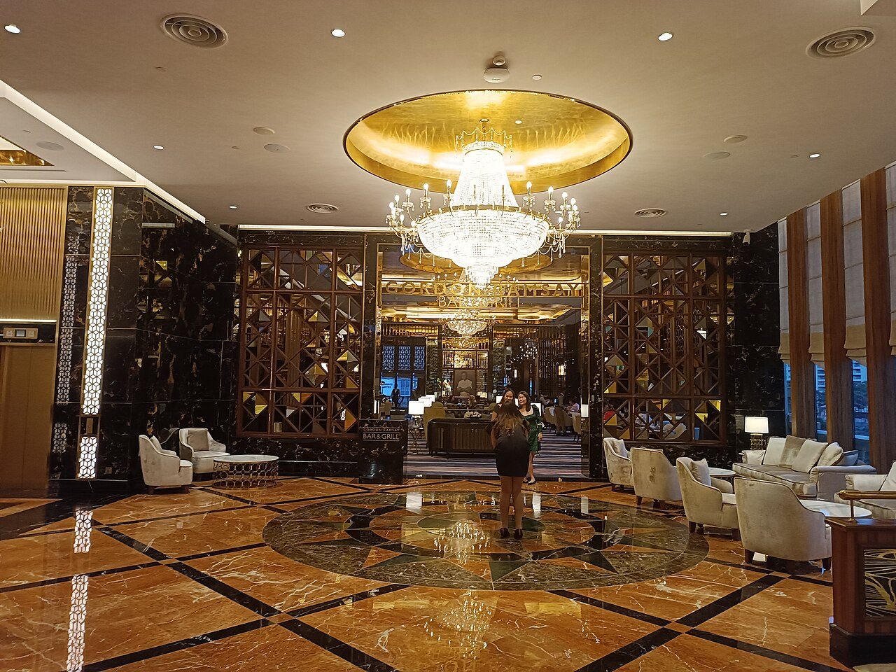 Entrance to Gordon Ramsay Bar & Grill off the marble lobby of Sunway Resort Hotel, Bandar Sunway, under a large chandelier