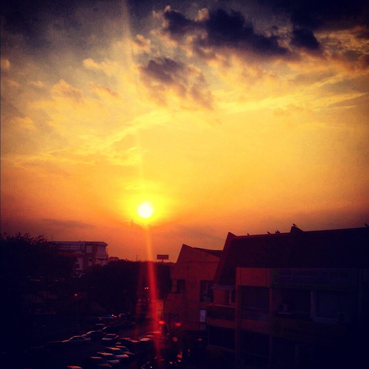 Sunset over shop-house rooftops and a car park in SS15, Subang Jaya