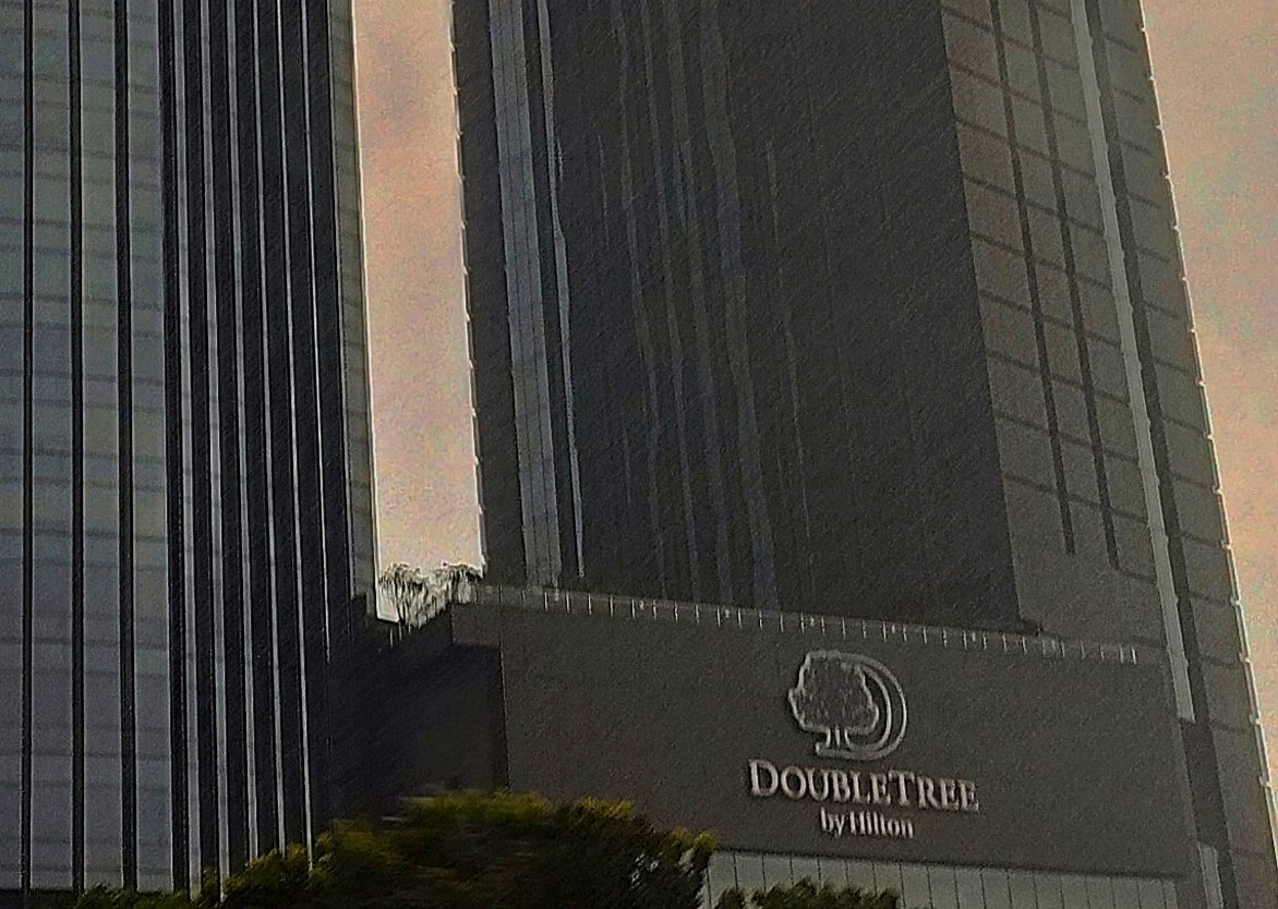 DoubleTree by Hilton logo on the base of the hotel tower at i-City, Shah Alam, next to an office tower