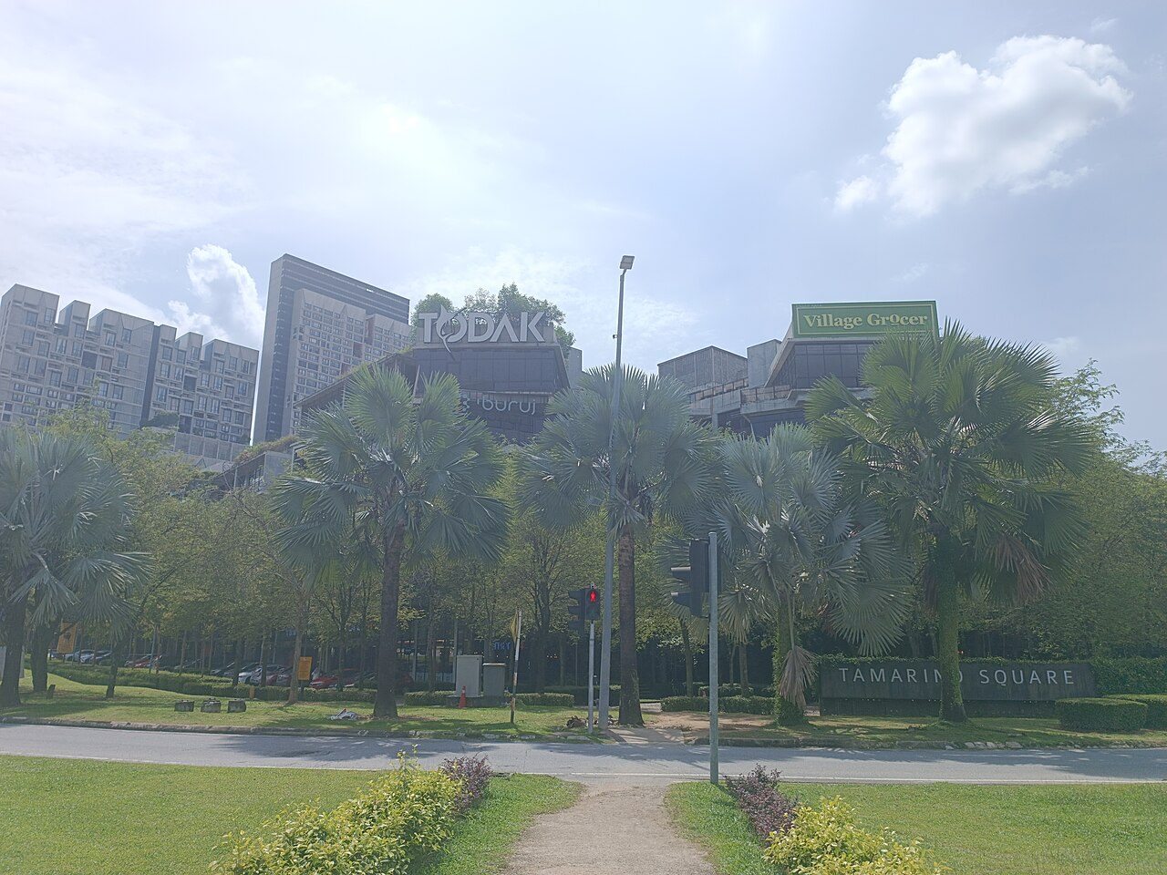 Tamarind Square in Cyberjaya, seen from across the road with its sign and palm trees in front