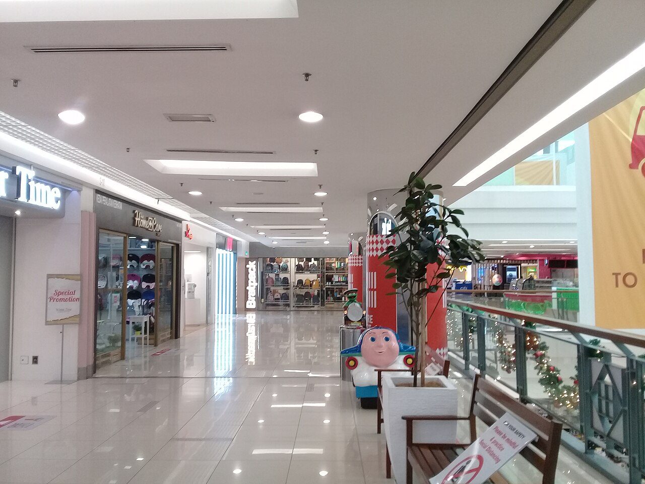 A shop-lined upper-floor walkway overlooking the atrium inside 1 Utama Shopping Centre