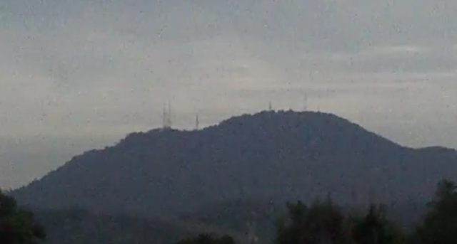 Gunung Kledang seen from Ipoh, a forested hill with radio masts on its summit