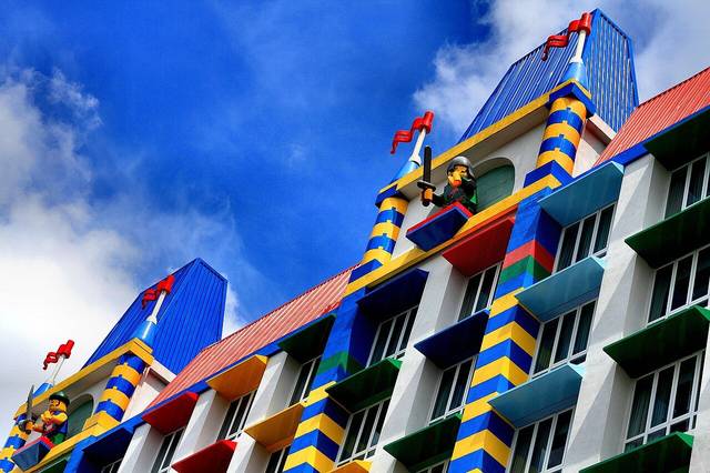 LEGOLAND Malaysia Hotel facade with brick-style striped columns, coloured window ledges and LEGO knight figures on the towers