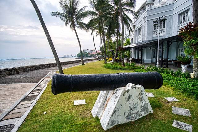 Seafront lawn and colonial facade of the Eastern & Oriental Hotel, one of the Penang hotels in George Town