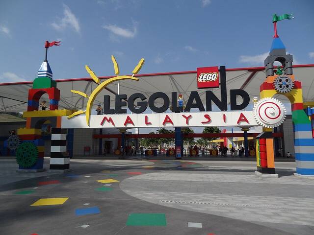 The entrance arch of LEGOLAND Malaysia, built to look like giant LEGO bricks, with the ticket gates behind
