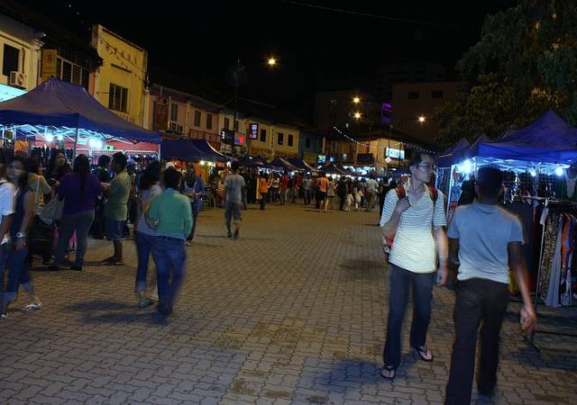 Shoppers walking between lit stall tents at the Bazar JB night market in central Johor Bahru, photographed in 2013 at its earlier site