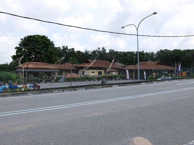 Low buildings with traditional Malay-style roofs at the Johor Craft Complex in Larkin, seen from the road