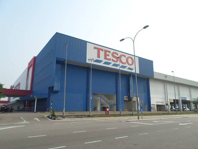 The blue hypermarket building in Bukit Indah in 2015, then branded Tesco, with an empty road in front