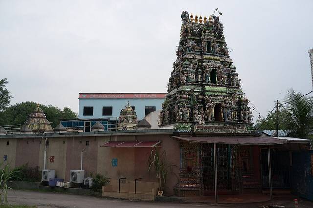 The gopuram of the Arulmigu Sri Rajakaliamman Glass Temple in Johor Bahru, covered in painted figures and glass mosaic