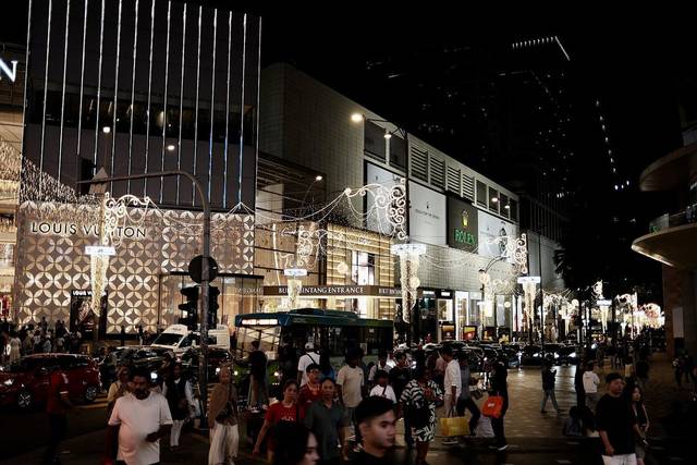 Crowds and festive lights along Jalan Bukit Bintang at night, Kuala Lumpur