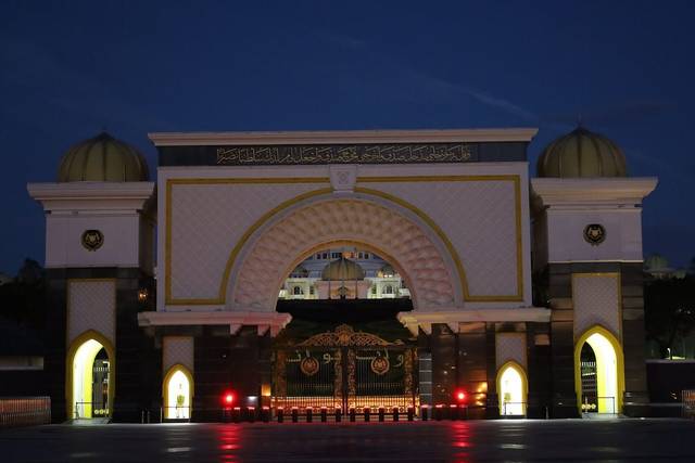 Main gate of Istana Negara, the National Palace in Kuala Lumpur, lit up at dusk