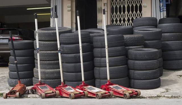 Tyres and floor jacks at a tyre repair shop in Gombak, on the edge of the city, for car repair in Kuala Lumpur