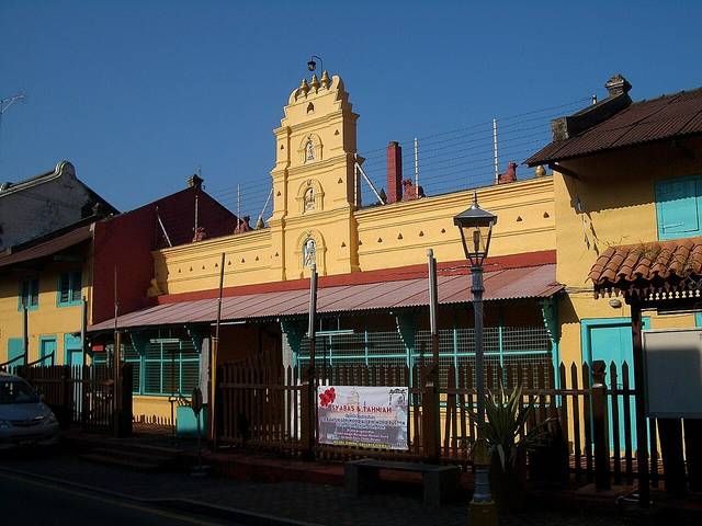 The yellow front of Sri Poyyatha Vinayagar Moorthi Temple on Jalan Tukang Emas with its small tiered tower