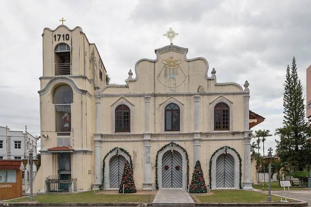 The cream facade of St Peter's Church in Melaka with its bell tower marked 1710