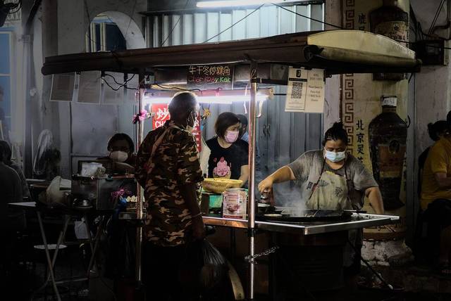 Char koay kak hawker cooking at a night stall on Lebuh Chulia, George Town, Penang