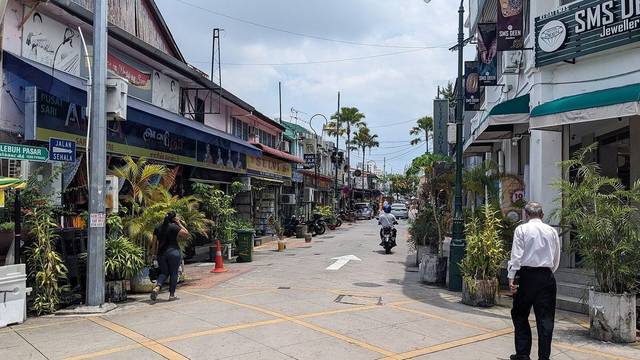 Shophouses, jewellers and potted plants along Lebuh Pasar in Little India, George Town, Penang