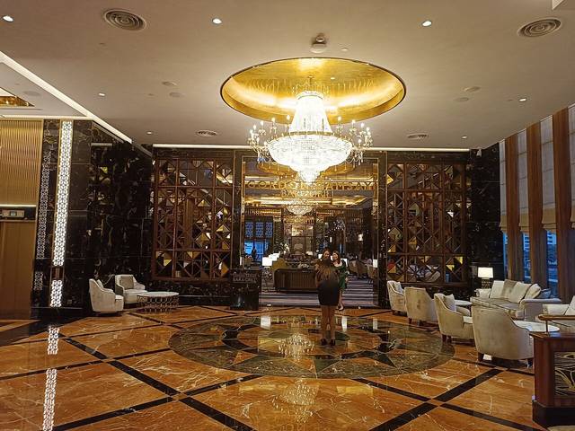 Entrance to Gordon Ramsay Bar &amp; Grill off the marble lobby of Sunway Resort Hotel, Bandar Sunway, under a large chandelier
