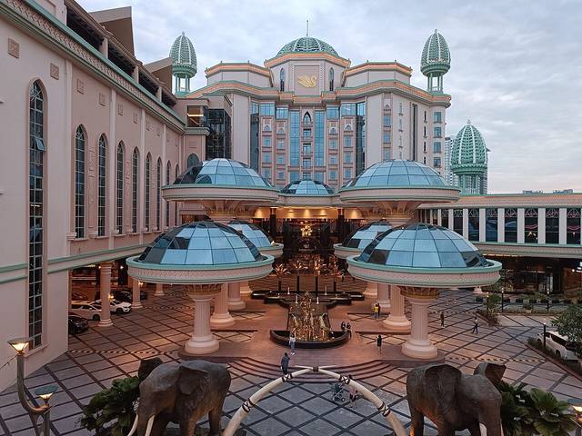 Sunway Resort Hotel entrance court with glass domes, a fountain and elephant statues in front of the hotel tower